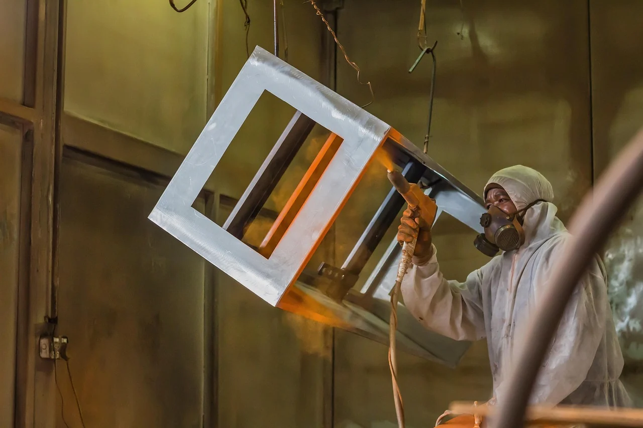 Powder coating sprayed onto a suspended metal frame