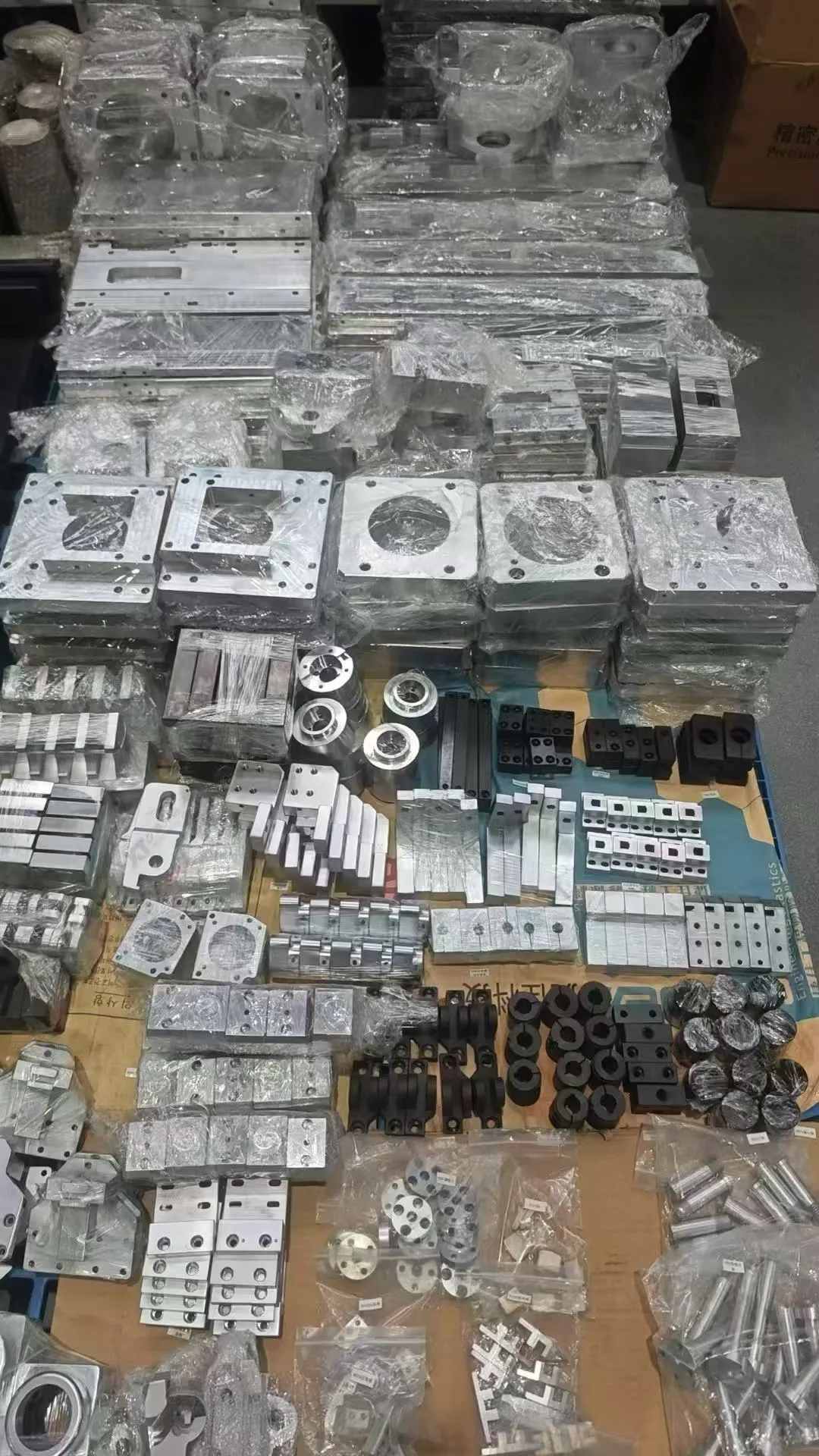 Small batch custom machined parts organized for shipment