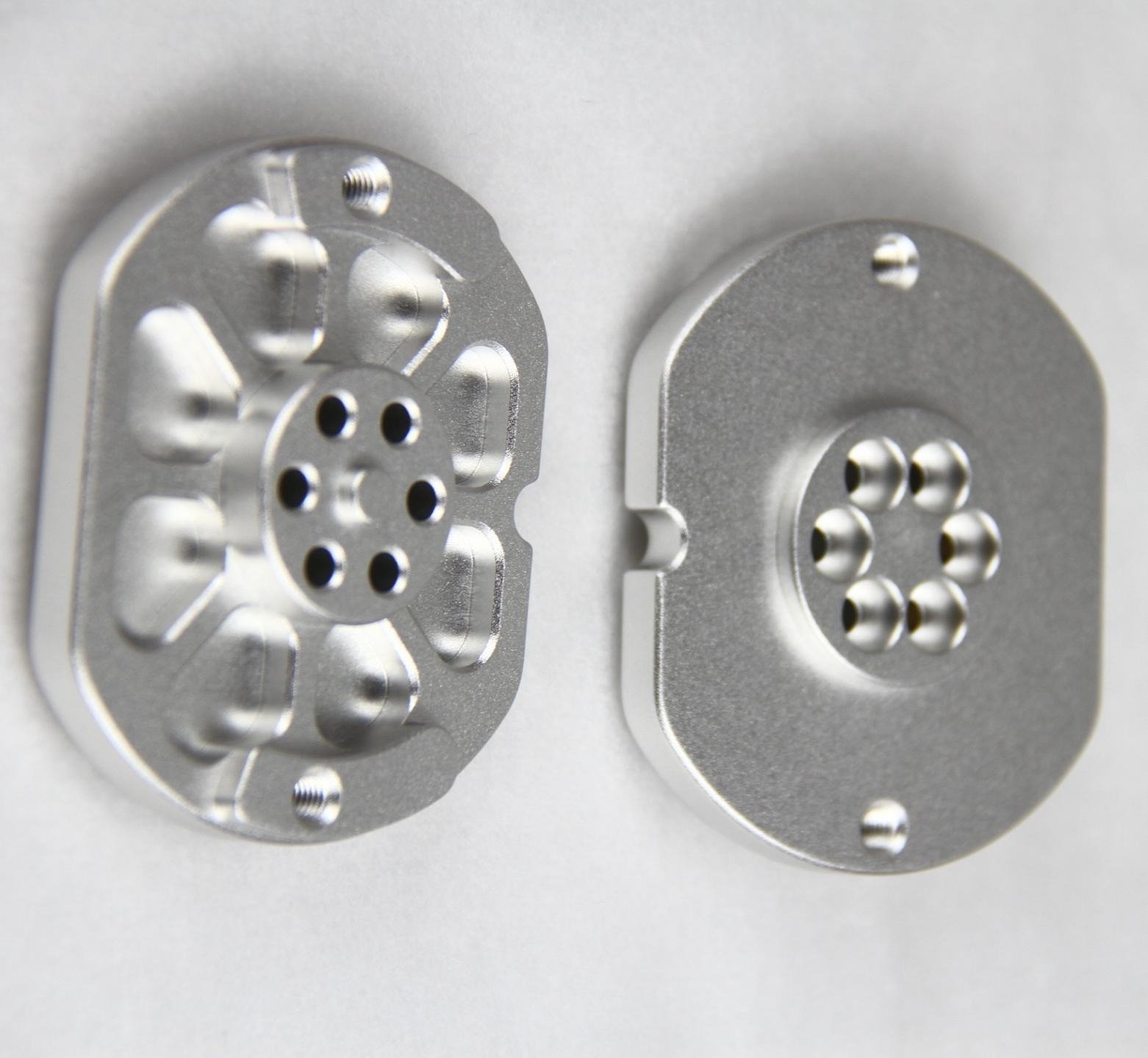 Machined plates with flat faces, recessed pockets and drilled features