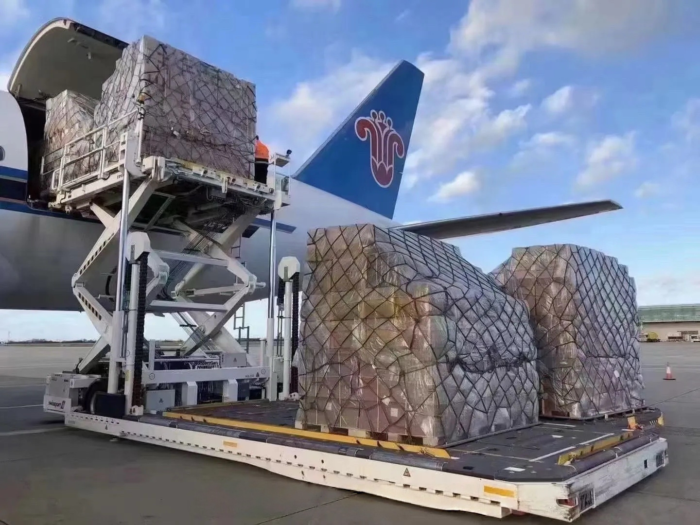 Air cargo pallets being loaded into an aircraft